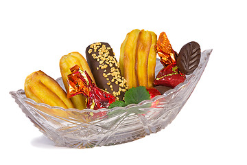 Image showing Cakes and sweets in a crystal vase on a white background