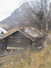 Image showing Old wooden house by the mountains