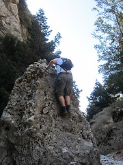 Image showing Man climbing a rock