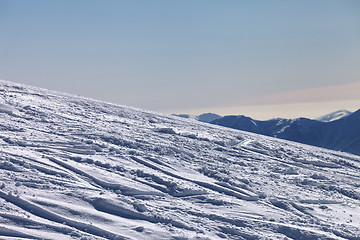 Image showing Ski slope with trace from ski and snowboards in newly - fallen s