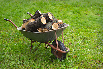 Image showing An old wheelbarrow full of firewood