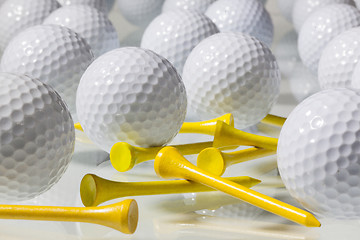 Image showing Many golf balls on a glass table