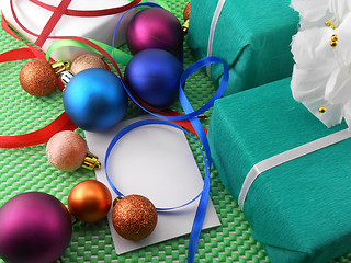 Image showing A gift box with a white ribbon and new year balls