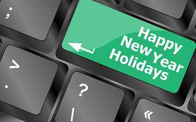 Image showing happy new year holidays button on computer keyboard key