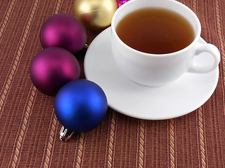 Image showing tea white cup and christmas baubles, holiday concept
