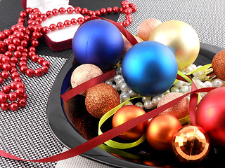 Image showing decorative christmas ball and pearls on a plate, new year holiday