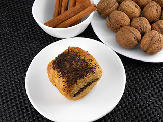 Image showing cake, walnut and cinnamon on white plate