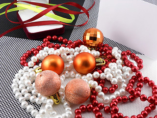 Image showing christmas ball and pearls on a plate, new year holiday card