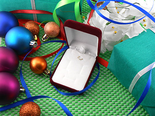 Image showing A gift box with a white ribbon and new year balls
