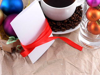 Image showing cup of coffee with coffee beans, christmas balls and invitation card