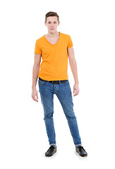 Image showing Young man wearing a yellow T-shirt and slim jeans