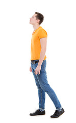 Image showing Young man wearing a yellow T-shirt and slim jeans