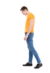 Image showing Young man wearing a yellow T-shirt and slim jeans