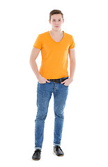 Image showing Young man wearing a yellow T-shirt and slim jeans