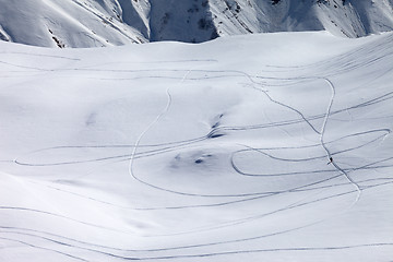 Image showing View on snowy off piste slope with trace from ski and snowboards