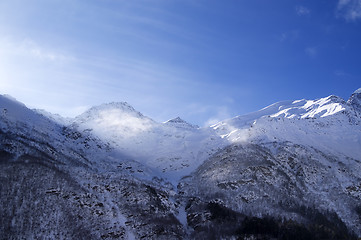 Image showing Snowy sunlight mountains, view from ski slope