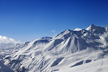 Image showing View on ski slope and beautiful mountains at sunny day