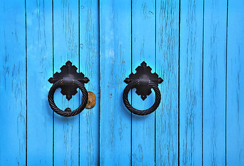 Image showing Blue wooden door with round handles