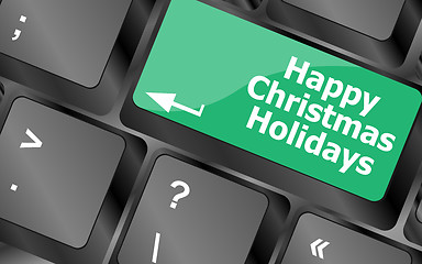 Image showing happy christmas holidays button on computer keyboard key