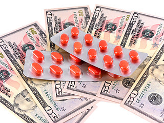 Image showing medical pills on dollars bank note as symbol for high costs