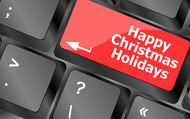 Image showing happy christmas holidays button on computer keyboard key