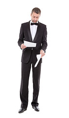 Image showing Man in a tuxedo reading the document