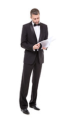 Image showing Man in a tuxedo reading the document