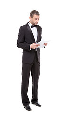 Image showing Man in a tuxedo reading the document