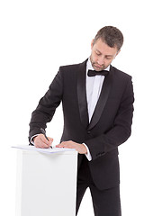 Image showing Man in a bow tie completing a form