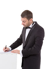 Image showing Man in a bow tie completing a form