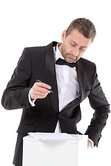 Image showing Man in a bow tie completing a form