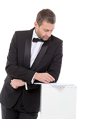 Image showing Man in a bow tie completing a form