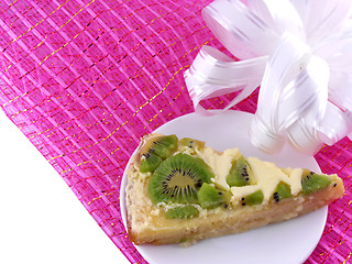 Image showing kiwi tasty cake close up at plate with white bow