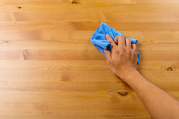 Image showing Cleaning table by hand