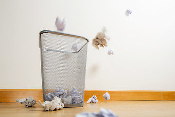 Image showing Silver trash bin and crumpled papers