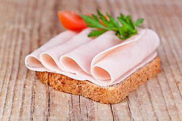 Image showing bread with sliced ham, fresh tomatoes and parsley