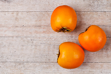 Image showing three fresh persimmons 