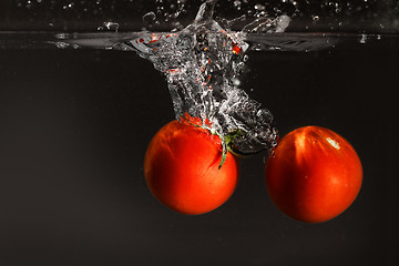 Image showing Fresh tomato dropped into water