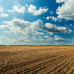 Image showing plowed field and cloudy sky in sunset