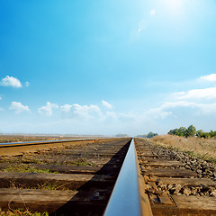 Image showing hot sun in blue sky over old railroad