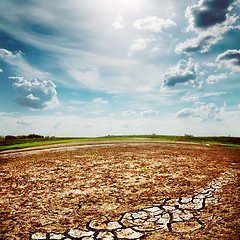 Image showing desert earth wirh cracks under dramatic sky