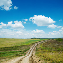 Image showing dirty road and blue sky with clouds