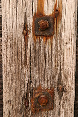 Image showing Rusty bolts against old timber 