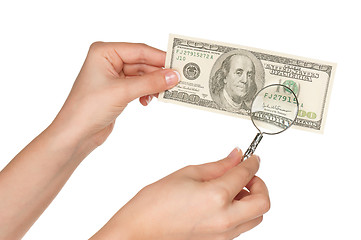 Image showing Hand with magnifying glass and dollars