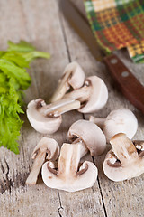 Image showing  fresh champignons and old knife 