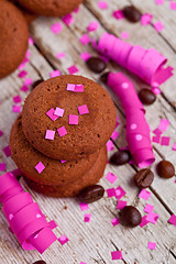 Image showing fresh chocolate cookies, coffee beans, pink ribbons and confetti