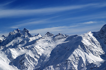 Image showing Snowy sunlight mountains, view from ski slope 