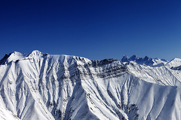 Image showing Snowy winter rocks in sun day