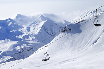 Image showing Chair lifts and off-piste slope in haze