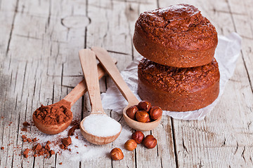 Image showing fresh baked browny cakes, milk, sugar, hazelnuts and cocoa powde